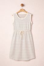 Striped dress hanging on a wooden hanger against a beige background